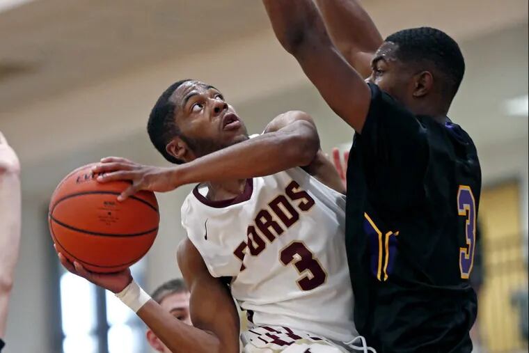 Haverford School’s Kharon Randolph puts up a shot while defended closely by Roman Catholic’s J.P. Sanders in December.