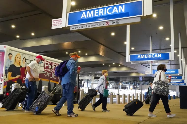 Passengers arrive at American Airlines in Philadelphia International Airport on Nov. 12, 2021.