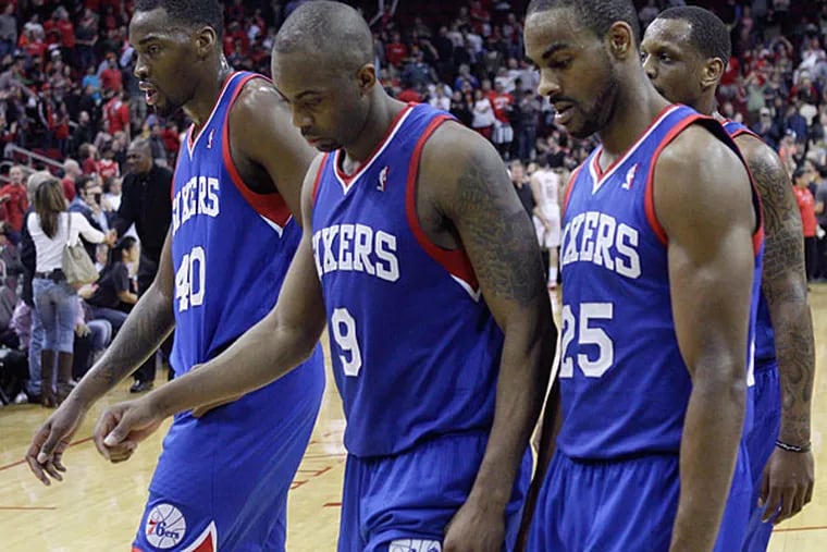 Jarvis Varnado (40), James Anderson (9) and Elliot Williams (25) walk of the court after losing to the Houston Rockets 120-98 for league tying 26th consecutive loss during an NBA basketball game, Thursday, March 27, 2014, in Houston. (Bob Levey/AP)