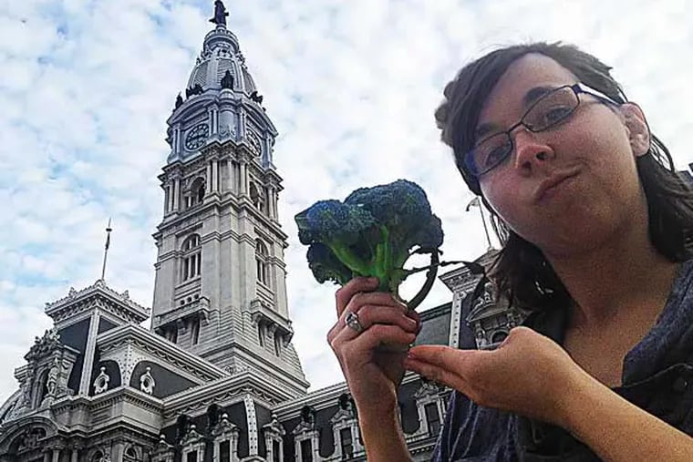 Humane League director Rachel Atcheson proffers fresh broccoli to City Hall, celebrating the Meatless Monday resolution passed by City Council in October. (Vance Lehmkuhl / Staff)