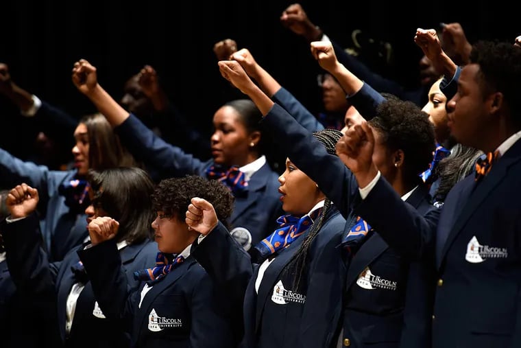 Lincoln University Concert Choir members salute at the start of a Julian Bond memorial service. More than 200 gathered at the university's International Cultural Center to remember the civil rights leader.