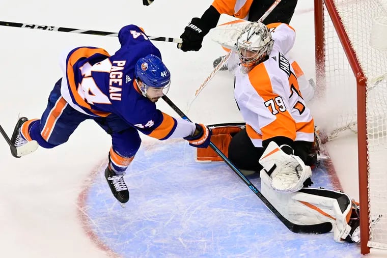 Flyers goaltender Carter Hart stops New York Islanders center Jean-Gabriel Pageau during overtime in Game 6. The Flyers won in double overtime, 5-4, as Hart stopped 49 of 53 shots.