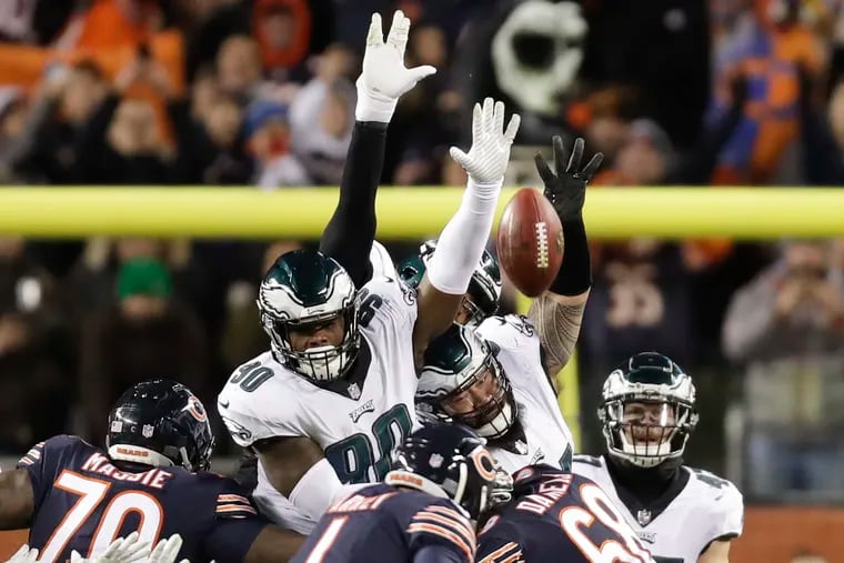 Eagles defensive tackle Treyvon Hester (left) and defensive tackle Haloti Ngata leap to block Bears kicker Cody Parkey's game winning field goal. Hester got a finger on the ball.