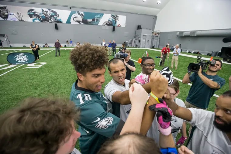 Mack Hollins of the Eagles was one of the coaches. He huddles up the Chester County team. Members of the Eagles teamed up with Special Olympics for a game of flag football and other activities in the Eagles' Novacare Complex on Sept. 4, 2018. CHARLES FOX / Staff Photographer