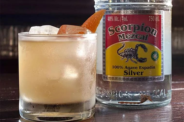 El Escorpi&#0243;n cocktail and bottle of Scorpion Mezcal Silver at Pub & Kitchen. (David M Warren/Staff Photographer)
