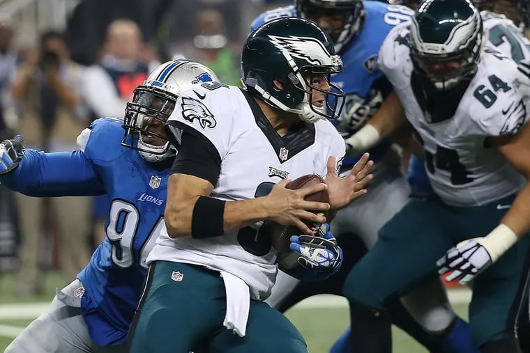 The Eagles' Mark Sanchez is sacked by the Lions' Ezekiel Ansah during the second quarter Thursday at Ford Field. (DAVID MAIALETTI / Staff Photographer)