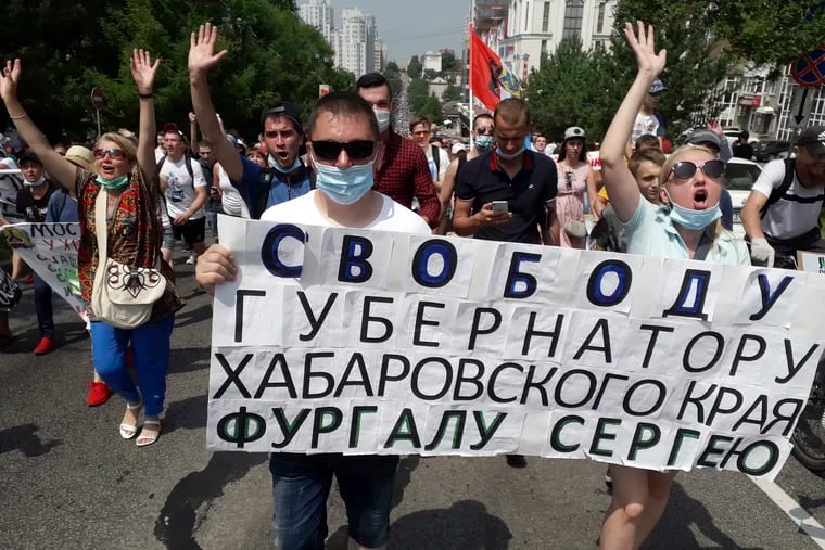 People hold posters reading "Freedom for Khabarovsk region's governor Sergei Furgal" during an unsanctioned protest in support of Furgal, who was interrogated and ordered held in jail for two months, in Khabarovsk, 6,100 kilometers (3,800 miles) east of Moscow, Russia, Saturday, July 18, 2020.