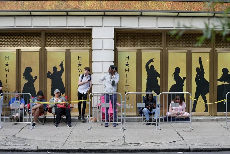 Fans wait in line to get wristbands that might give them an opportunity to buy tickets for the musical "Hamilton" at the Forrest Theatre on July 9, 2019