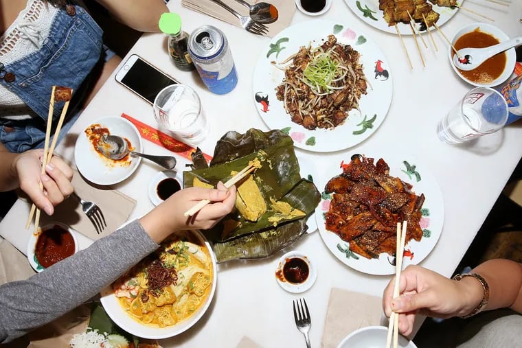 Some of the dishes in the "Crazy Rich Asians" dinner spread are pictured at Saté Kampar in South Philadelphia on Wednesday, Sept. 19, 2018. The restaurant is offering a reservation-only "Crazy Rich Asians" themed dinner.