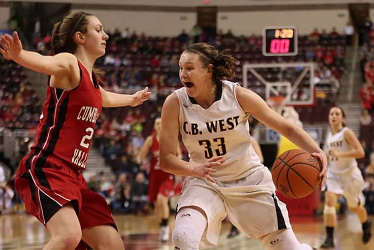 Central Bucks West's Nicole Munger is guarded by Cumberland Valley's Kelly Jekot as she drives to the basket in the state final. Munger finished with nine points Friday in her last game for the Bucks. Jekot scored 3 points for the winners. (David Swanson/Staff Photographer)