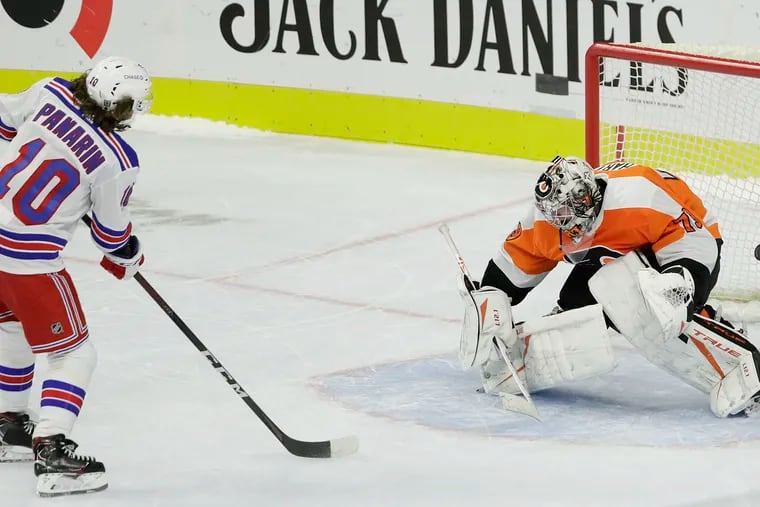 Rangers forward Artemi Panarin scores on Flyers goaltender Carter Hart during a shootout last Thursday.