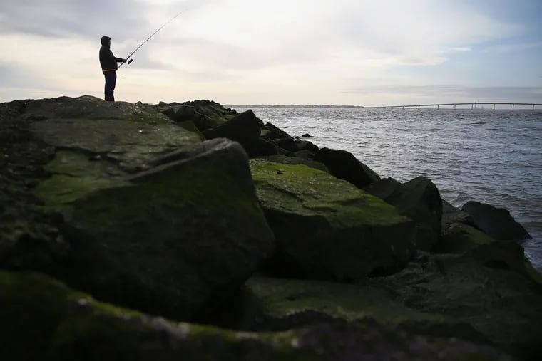 Ulan Jakypbekov of Bensalem fishes at the southern point of Longport, N.J. on Friday.