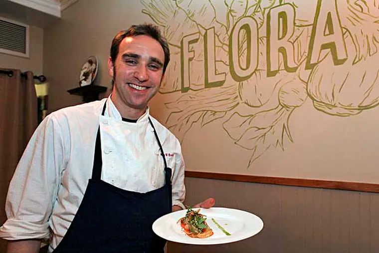 Head chef Max Hosey from Flora restaurant in Jenkintown holds a persimmon salad with mission figs and pine nuts, Saturday Jan. 3, 2015.  (For the Daily News/ Joseph Kaczmarek)