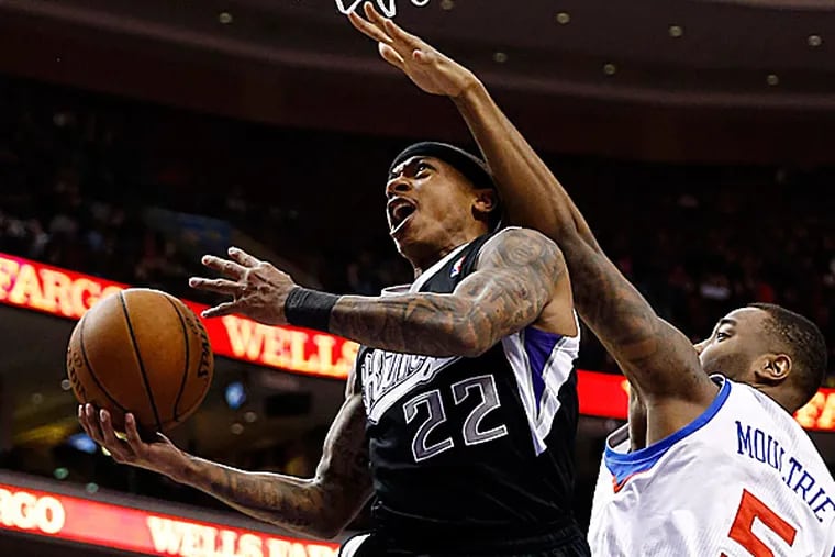 The Kings' Isaiah Thomas goes up to shoot against the 76ers' Arnett Moultrie during the first half. (Matt Slocum/AP)