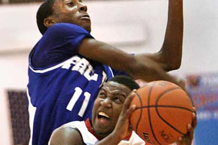 Pennsauken's #2 Takwail Bailey (bottom) is fouled by Paul VI #11 Ron Curry during the second half of the Paul VI at Pennsauken H.S. boys' basketball game.  (Elizabeth Robertson / Staff Photographer)