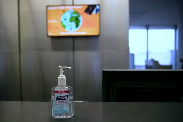 A Purell hand sanitizer bottle sits on a counter of a check-in gate inside Terminal A of the Philadelphia International Airport on Wednesday, March 3, 2020.