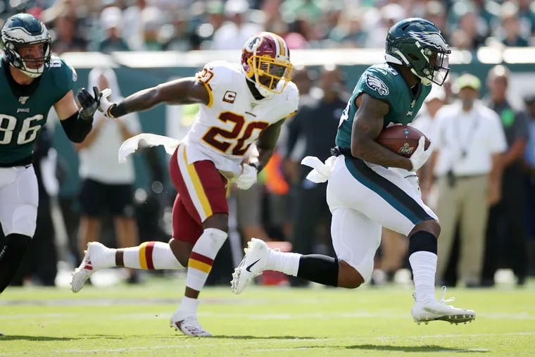 Eagles running back Miles Sanders runs the ball against the Washington Redskins in the season opener at Lincoln Financial Field .