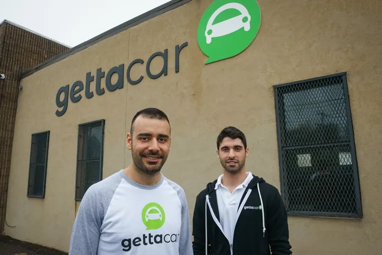 Yossi Levi (left), founder and CEO, and Jake Levin, founder and chief marketing officer, shown here at the Gettacar reconditioning center in Northeast Philadelphia.