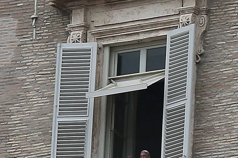 DAVID MAIALETTI / STAFF PHOTOGRAPHER Pope Francis speaks from his window in Vatican City yesterday.