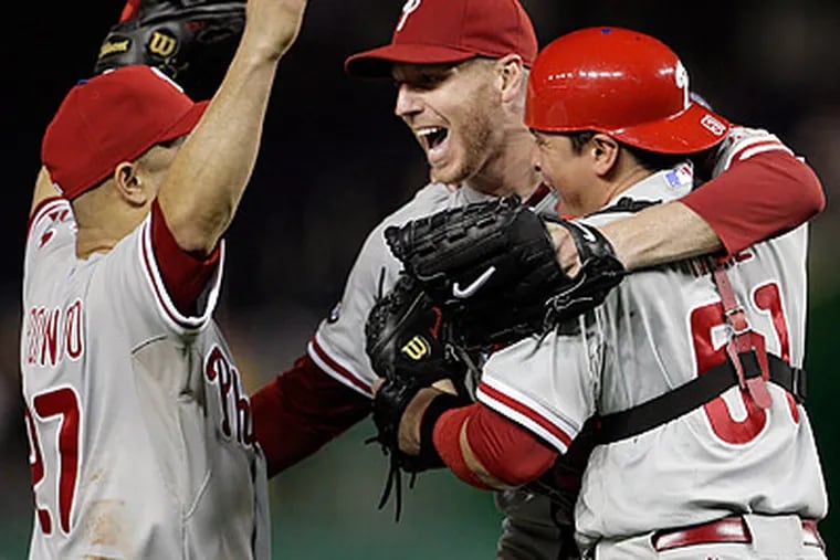 Placido Polanco, Roy Halladay and Carlos Ruiz celebrated after the final out of last night's win. (Yong Kim/Staff Photographer)