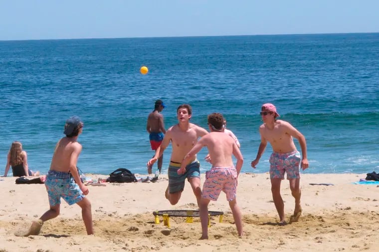 This May 21, 2018, photo shows beachgoers playing spikeball on the sand in Belmar, N.J. New Jersey legislators are trying to enshrine in law the public's right to access and use the state's waterways and adjacent shorelines.