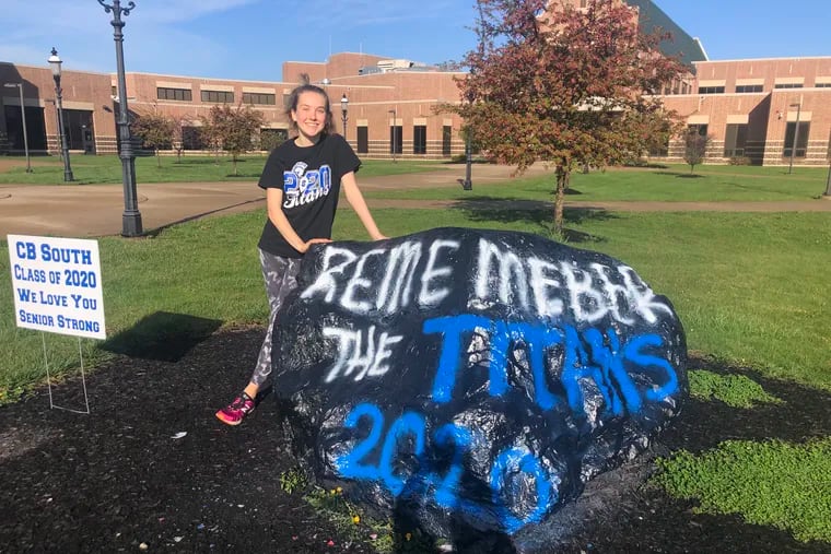 Central Bucks High School South senior Laura Bernert with the boulder commemorating her senior class, which is finishing their year remotely due to the coronavirus.