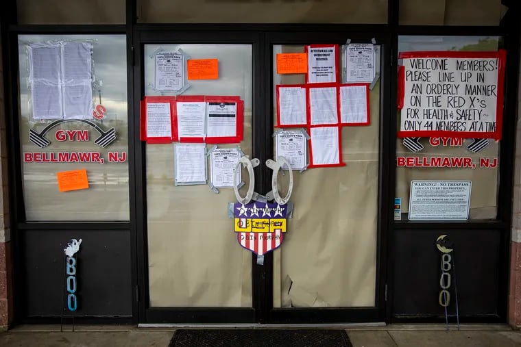 The entrance of Atilis Gym is covered with letters with warnings and including notice of embargo from Camden County, N.J., on the closure of the gym on Saturday, May 23, 2020.