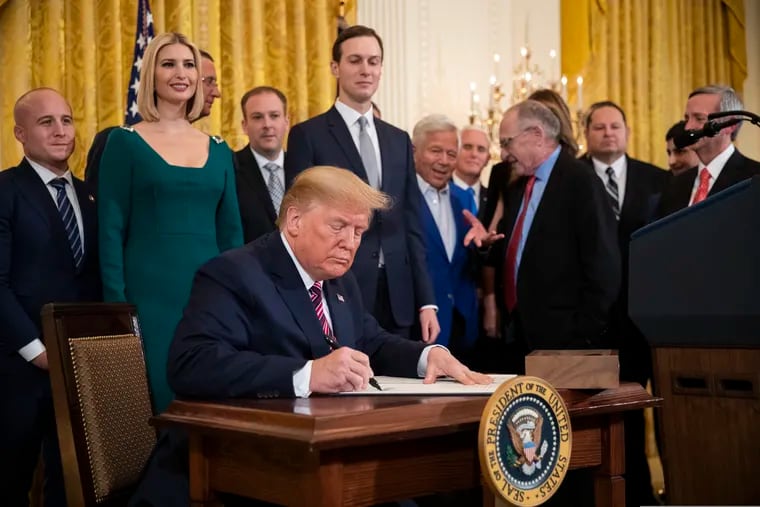 President Donald Trump signs an executive order combating anti-Semitism in the U. S. during a Hanukkah reception in the East Room of the White House.