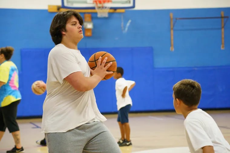 Miguel Batiz plays basketball during summer camp at the Greater Philadelphia YMCA, in Northeast Philadelphia, July 12, 2019. Batiz received a grant from the city’s Dept. of Behavioral Health to attend four weeks of summer camp.