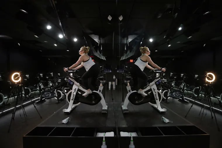 Jamie Promislo, owner of Revel Ride, an indoor cycle studio in Philadelphia, took her classes virtual amid Philadelphia’s COVID-19 restrictions. Gyms are among facilities that will be reopening in Philadelphia and around Pennsylvania on Monday under revised restrictions that include operating at 50% capacity.