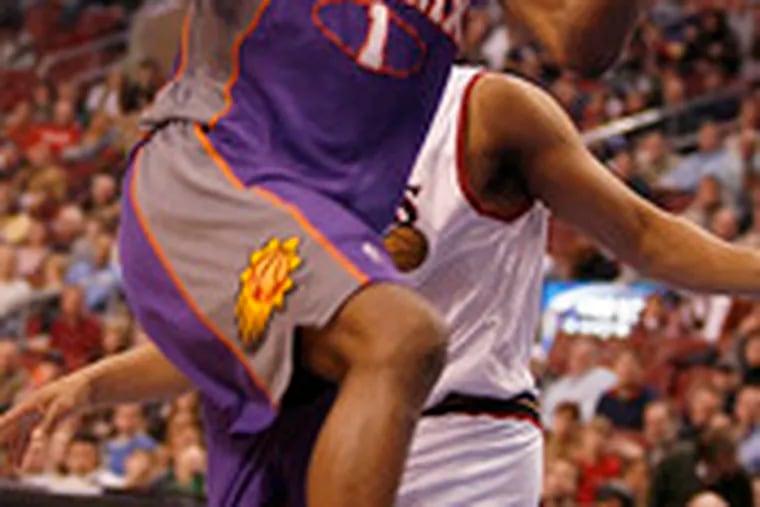 The Suns&#0039; Amare Stoudemire loses the ball as he goes up for a layup in the first quarter. The Sixers&#0039; Andre Miller is behind him.