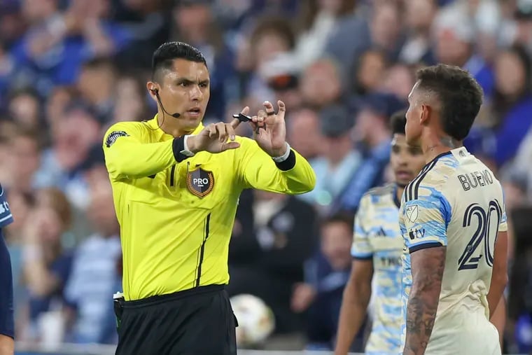 Referee Rafael Bonilla warns Union midfielder Jesús Bueno as things get chippy in the second half on Saturday in Kansas City.