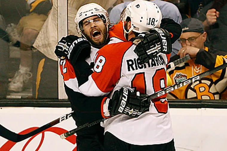 Simon Gagne, left, and Mike Richards celebrate Gagne's goal in the third period. (David Maialetti / Staff Photographer)