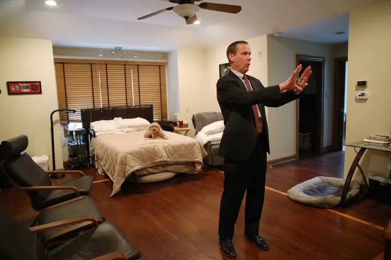 Bill Gill explains the modifications in his son's bedroom in the Gill family's ADA-compliant home in Naperville, Ill. This includes a 36-inch doorway, wider wheelchair accessible closets, and rooms wired so that electronics can be turned on and off from a remote.