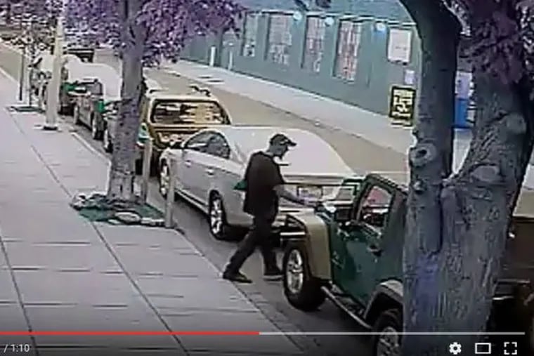 Surveillance tape of a man stealing a battery June 20 from a Jeep Wrangler on  the 2000 block of Lombard Street. Police believe he is Juan Carlos Lugo, a.k.a. Carlos Martinez.