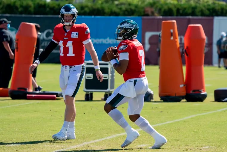 Carson Wentz watches Jalen Hurts at training camp -- a scene that could replicate itself if Wentz’s play doesn't improve soon.