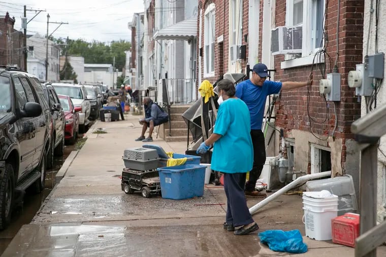 Residents along Second Street in Bridgeport clean out their homes after Ida-related flooding earlier this month. A flash flood watch is up, but no Ida repeat is expected.