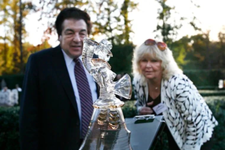 In happier times: Harry Madonna, a founder of Republic First Bancorp, and Charlene Madonna look at a glass sculpture made by the Seguso glassworks of Murano, Venice, Italy, which is owned by Vernon Hill. The two former allies are now fighting for control of the bank. Another former Hill ally, George Norcross, supports Madonna's group.