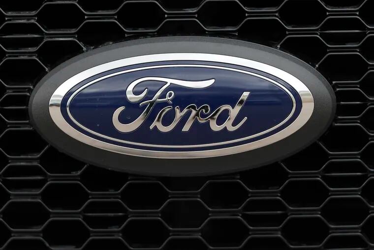 FILE- In this Feb. 17, 2019, file photo the company logo is displayed on the grille of an unsold 2019 F150 pickup truck at a Ford dealership in Broomfield, Colo. Ford is almost finished with a major global restructuring, and by the time it ends in August the automaker will have shed 7,000 white-collar jobs. The company said Monday, May 20 that the plan will save about $600 million per year by eliminating bureaucracy and increasing the number of workers reporting to each manager. (AP Photo/David Zalubowski, File)