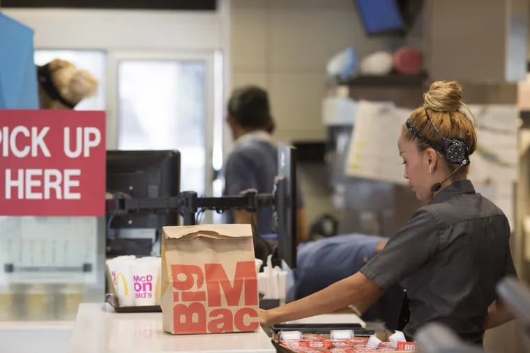 An employee packs an order for a customer at a McDonald's restaurant in Phoenix, Ariz.