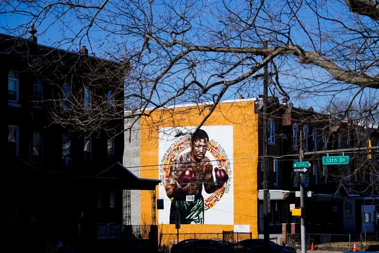 A new Mural Arts Philadelphia painting honoring Joe Frazier on the 50th anniversary of the boxer's World Heavyweight championship bout against Muhammad Ali, in shown on the side of a building in Philadelphia, Monday, March 8, 2021. (AP Photo/Matt Rourke)