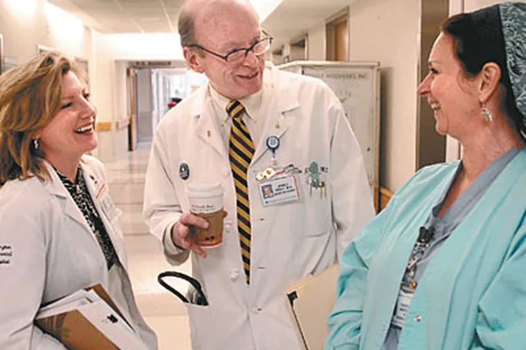 Abington Memorial Hospital chief of staff John J. Kelly talks with nurses Peg Below (left) and Deborah Anderson. Before Pat Zakrzewski died, Kelly got her permission to use her story in campaigning against infections. (Tom Gralish / Staff Photographer)