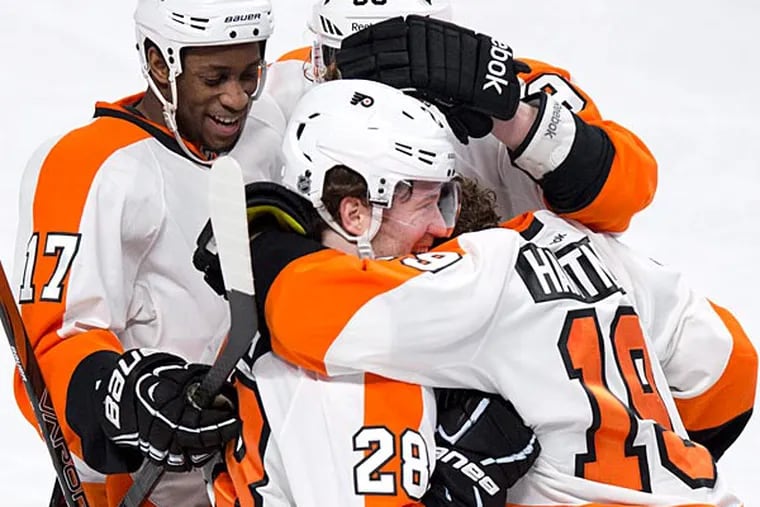 Philadelphia Flyers' Scott Hartnell, right, is congratulated by Wayne
Simmonds, Claude Giroux and Jakub Voracek for his goal during the second period, Monday, April 15, 2013, in Montreal. (Paul Chiasson/The Canadian Press/AP)