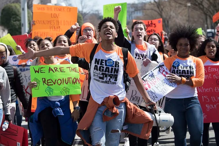 Christian Carter, from Pennsylvania, leads a group of Pennsylvania students as they walk down Pennsylvania Ave. in Washington D.C. during the March for Our Lives rally on Saturday, March 24, 2018.