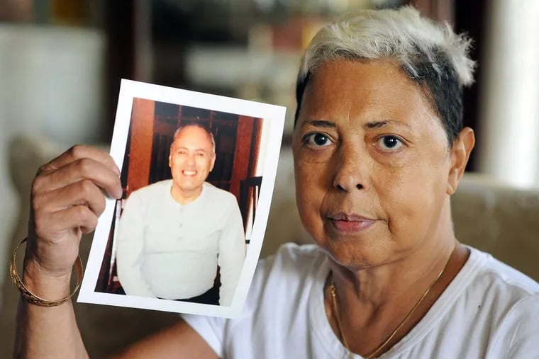 Miriam Rodriguez holds a photograph of her brother Frank Rodriguez in her living room in Bethlehem, Pennsylvania. Frank Rodriguez was on death vigil in prison for 10 weeks before finally being granted compassionate release. He died a day and a half later. (WILLIAM THOMAS CAIN / For The Philadelphia Inquirer)