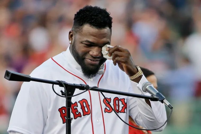 FILE - In this June 23, 2017, file photo, Boston Red Sox baseball great David Ortiz wipes a tear at Fenway Park in Boston as the team retires his number "34" worn when he led the franchise to three World Series titles. Ortiz was back in Boston for medical care after authorities said the former Red Sox slugger affectionately known as Big Papi was ambushed by a gunman at a bar in his native Dominican Republic. A plane carrying the 43-year-old retired athlete landed Monday night, June 10, 2019, after a flight from the Dominican Republic, the team said.
