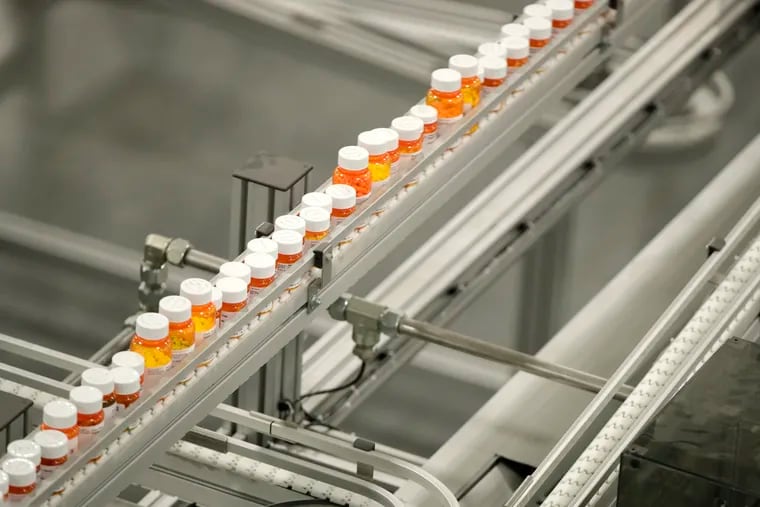 In this July 10, 2018, file photo, bottles of medicine ride on a belt at the Express Scripts mail-in pharmacy warehouse in Florence, N.J.