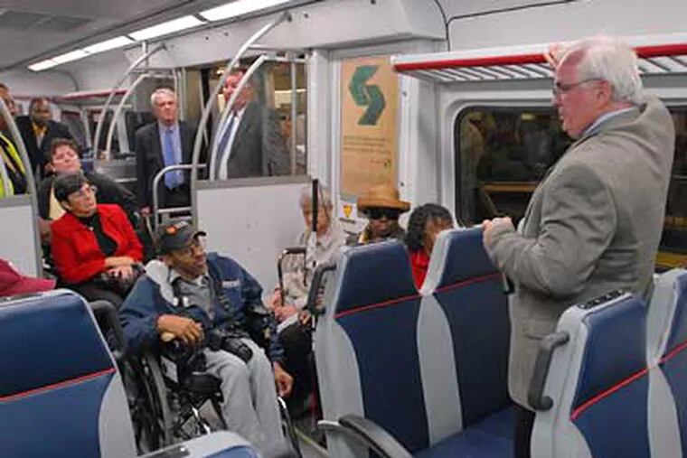 SEPTA's Dave Casper explains the new features of the railcar of the future to members of the SEPTA advisory board for accessable transportation during a tour of the car at Surban Station. (Ron Tarver/Staff Photographer)