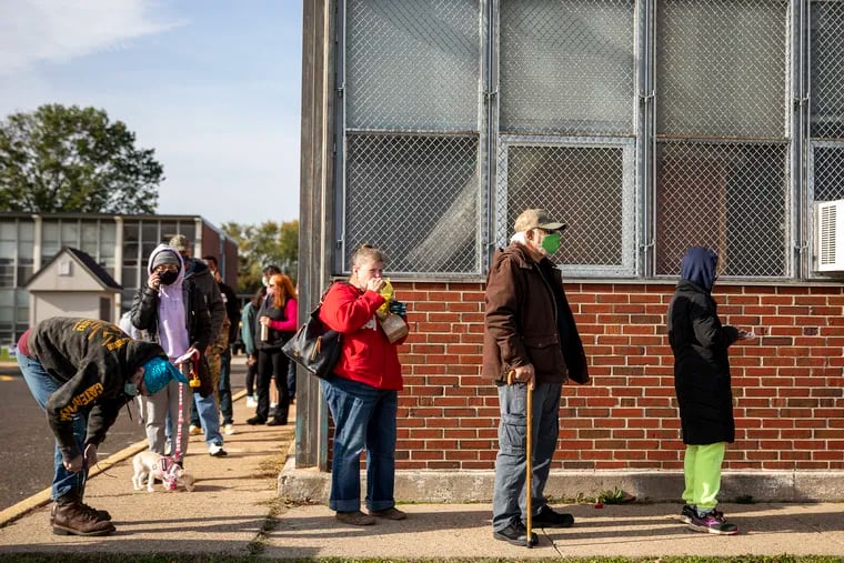 Voters line up outside of Franklin D. Roosevelt Middle School on Election Day in Bristol, Pa., on Tuesday, Nov. 3, 2020.