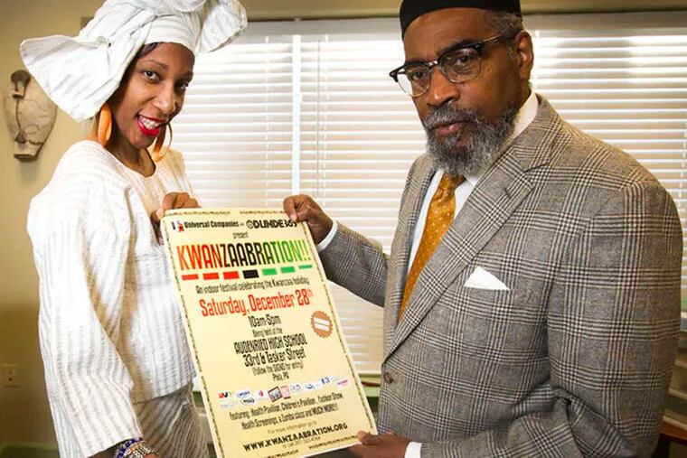 Fernandez and Gamble display the poster for Kwanzaabration!! ( ALEJANDRO A. ALVAREZ / STAFF PHOTOGRAPHER )